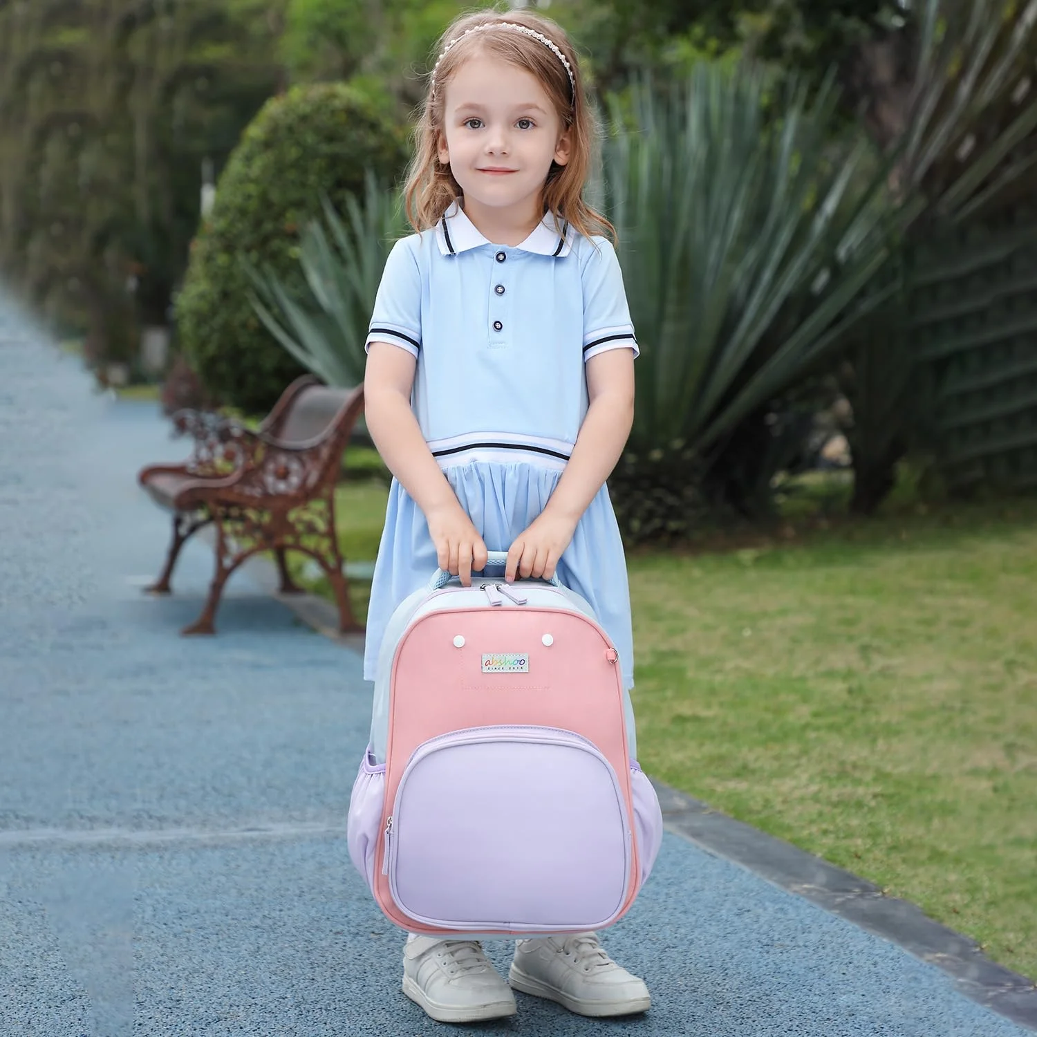 A preschool pack on a small back: the base of the bag stops above the waist